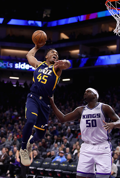 SACRAMENTO, CA - JANUARY 17:  Donovan Mitchell #45 of the Utah Jazz dunks over Zach Randolph #50 of the Sacramento Kings at Golden 1 Center on January 17, 2018 in Sacramento, California. NOTE TO USER: User expressly acknowledges and agrees that, by downloading and or using this photograph, User is consenting to the terms and conditions of the Getty Images License Agreement.  (Photo by Ezra Shaw/Getty Images)